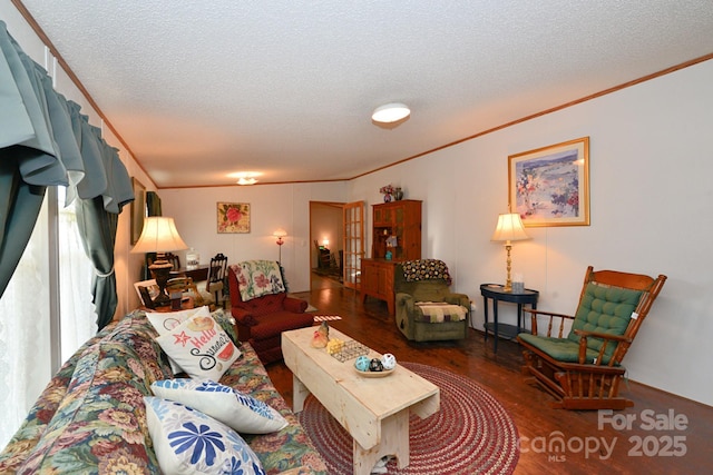 living room featuring hardwood / wood-style floors, a textured ceiling, and ornamental molding