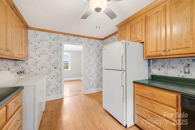 kitchen with black dishwasher, white fridge, ceiling fan, independent washer and dryer, and light hardwood / wood-style floors