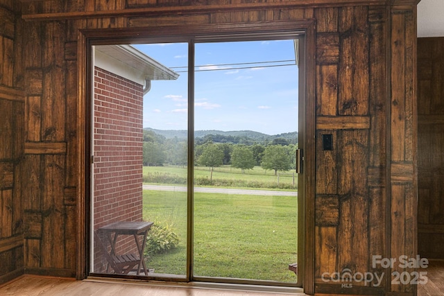 doorway to outside with a mountain view and light hardwood / wood-style floors