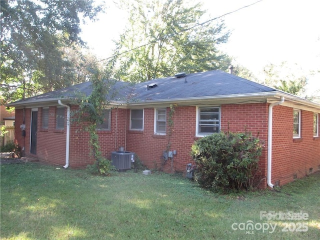 exterior space with a yard and central AC