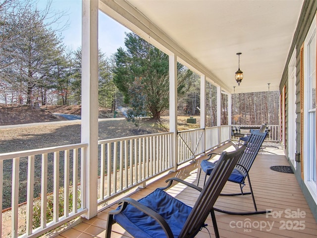 wooden terrace featuring covered porch