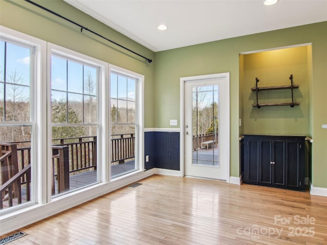 doorway to outside with light wood-type flooring