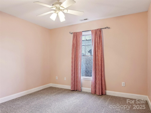 carpeted empty room featuring ceiling fan