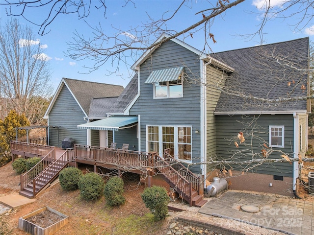 rear view of house with central AC and a deck