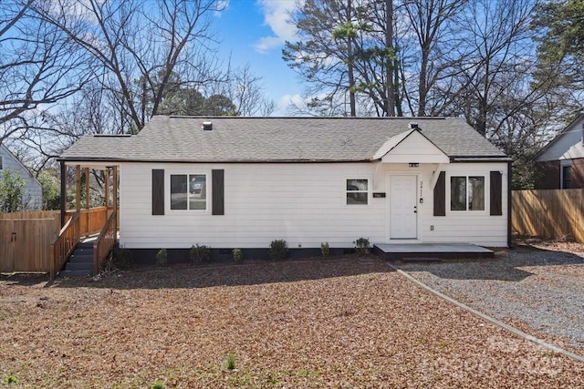 3411 Rogers St, Charlotte, NC 28208 - view of front facade featuring a patio, roof with shingles, and fence