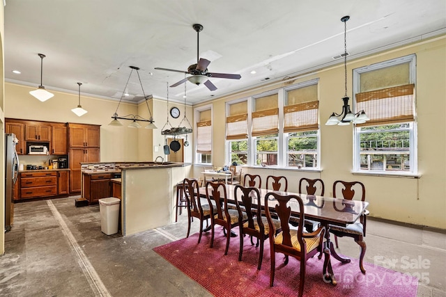 dining room with crown molding and ceiling fan