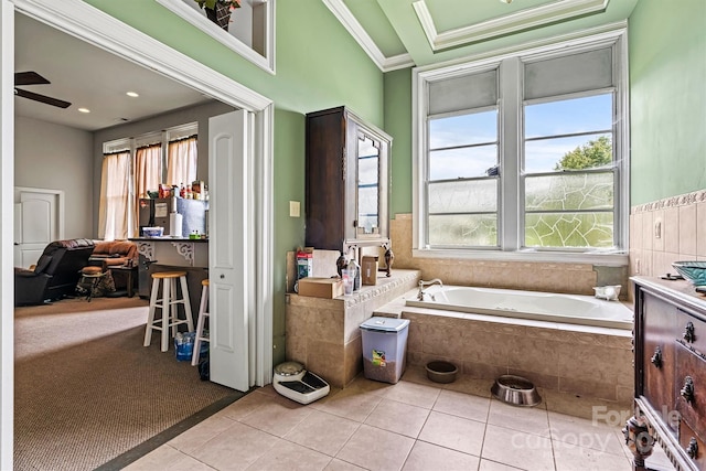 bathroom featuring tile patterned flooring, crown molding, tiled bath, and ceiling fan