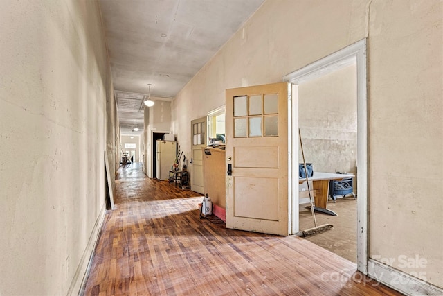 hall with wood-type flooring