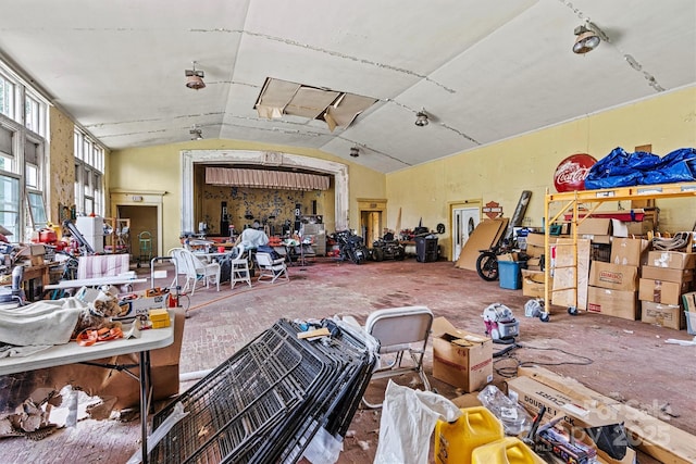 miscellaneous room with vaulted ceiling and a workshop area