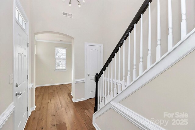 entrance foyer with light hardwood / wood-style floors and a high ceiling