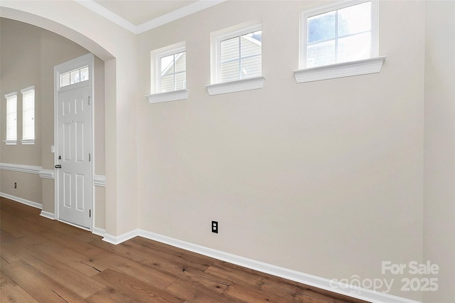 foyer entrance featuring ornamental molding and hardwood / wood-style floors