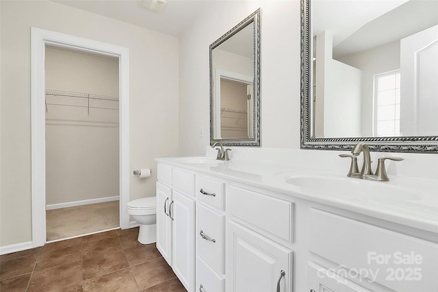 bathroom featuring vanity, tile patterned floors, and toilet