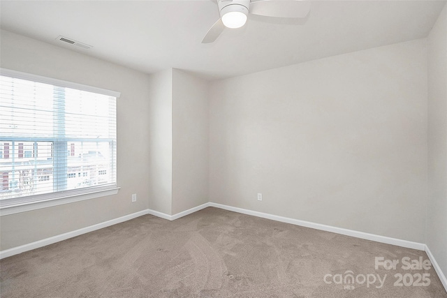 spare room featuring ceiling fan and carpet flooring