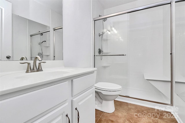 bathroom featuring tile patterned flooring, vanity, an enclosed shower, and toilet