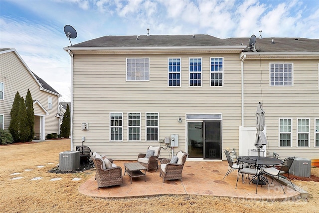 rear view of property featuring central AC and a patio area