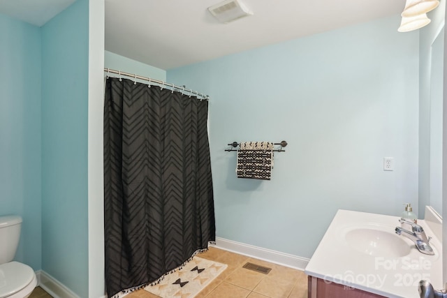 bathroom with vanity, toilet, curtained shower, and tile patterned flooring