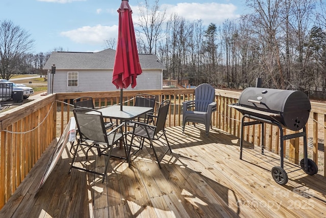 wooden terrace featuring a grill