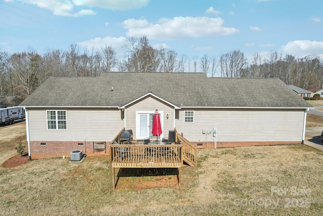 rear view of property with a deck and a lawn