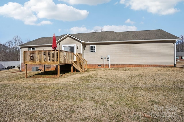 back of house featuring cooling unit, a deck, and a lawn