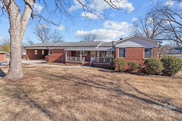 back of house with a lawn and covered porch