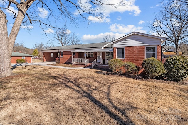 view of front of home with a porch and a front lawn