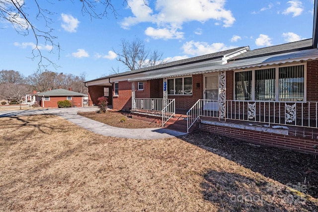 view of front of home featuring a front lawn and a porch