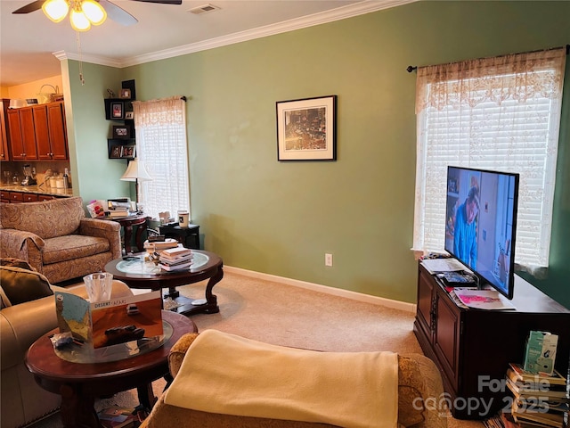 living room featuring crown molding, ceiling fan, and carpet