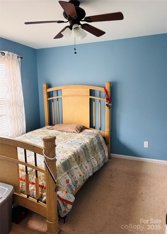 bedroom featuring ceiling fan and carpet