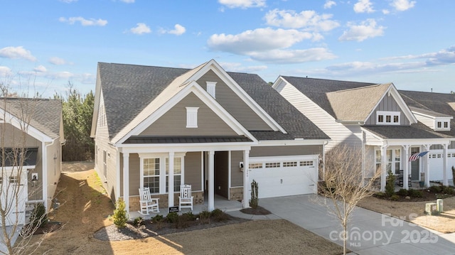 view of front of property with covered porch and a garage