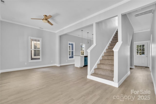 unfurnished living room featuring hardwood / wood-style floors, crown molding, and ceiling fan