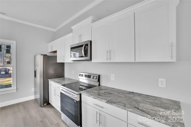 kitchen featuring white cabinetry, light stone counters, light wood-type flooring, ornamental molding, and stainless steel appliances