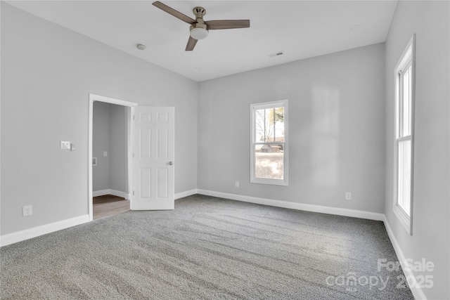 spare room featuring carpet floors and ceiling fan