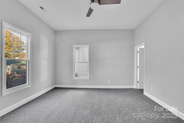 carpeted spare room featuring ceiling fan