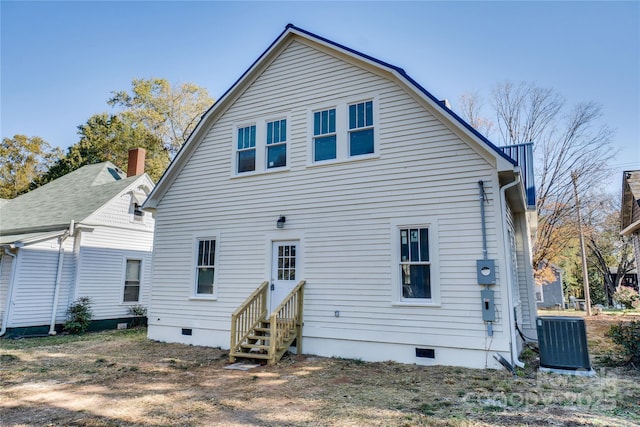 rear view of property with central AC