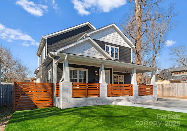 view of front of house with a porch and a front yard