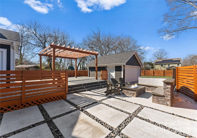 view of patio / terrace with a garage, an outdoor structure, a pergola, a deck, and a fire pit