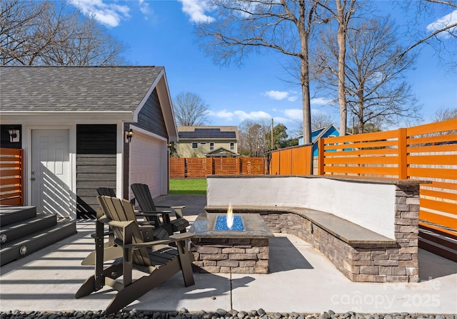 view of patio / terrace with an outdoor structure and a fire pit