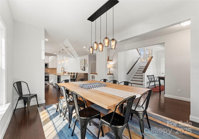 dining area with dark wood-type flooring and sink