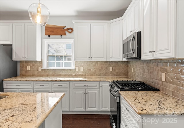 kitchen with white cabinetry, hanging light fixtures, stainless steel appliances, light stone countertops, and decorative backsplash