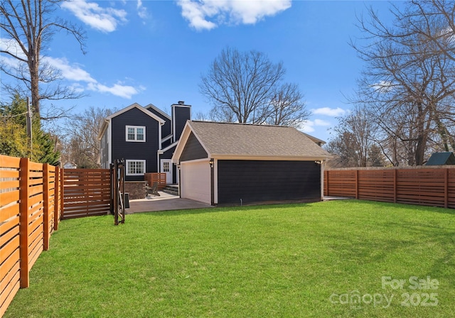 back of property with a garage and a yard