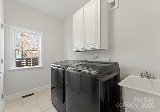 laundry room featuring sink, cabinets, washing machine and clothes dryer, and light tile patterned flooring