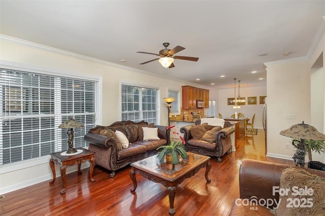 living room featuring crown molding, ceiling fan, and light wood-type flooring