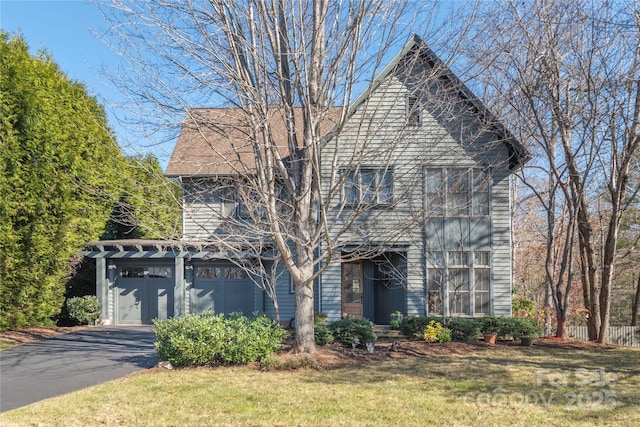 view of front of property featuring a garage and a front yard