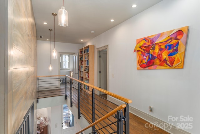 hall with hardwood / wood-style flooring