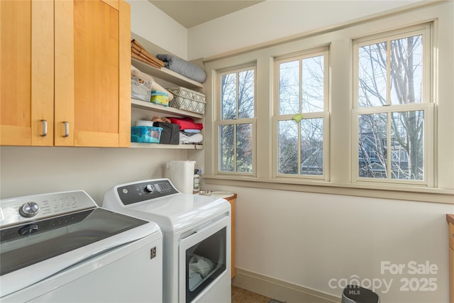 laundry room with cabinets, plenty of natural light, and independent washer and dryer