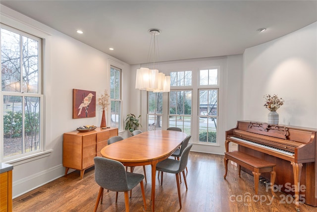 dining space with recessed lighting, visible vents, baseboards, and wood finished floors