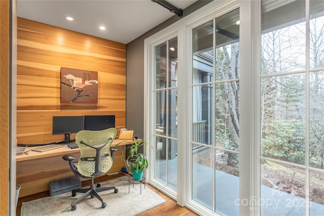 office area with wood walls, wood finished floors, and recessed lighting