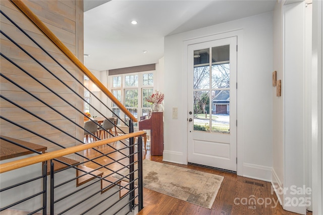 foyer featuring recessed lighting, wood finished floors, visible vents, baseboards, and stairway