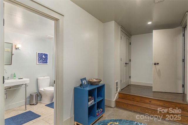 bathroom featuring toilet, baseboards, visible vents, and recessed lighting