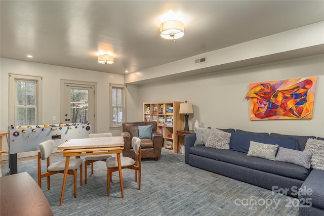 living area with carpet floors and visible vents